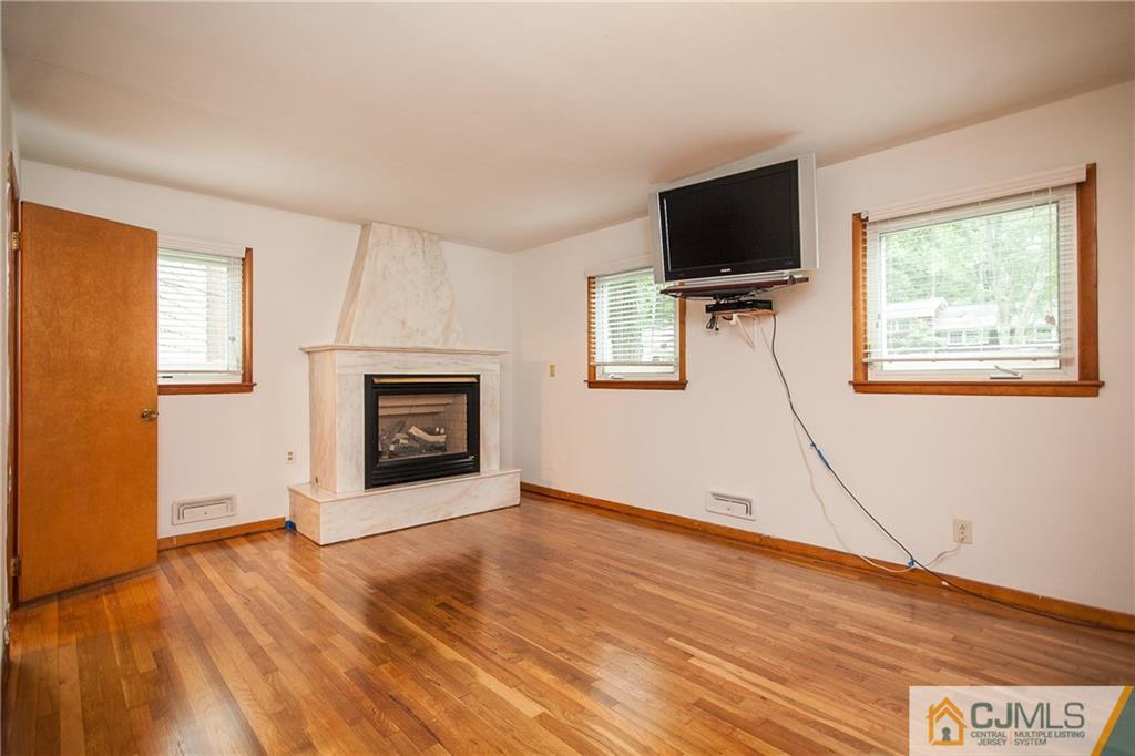 91 George Avenue Edison, NJ 08820 - Photo 10 of 21 a view of an empty room with a fireplace and a window