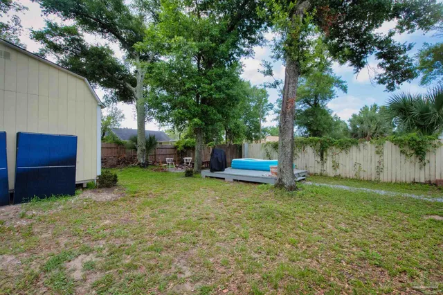 a backyard of a house with table and chairs