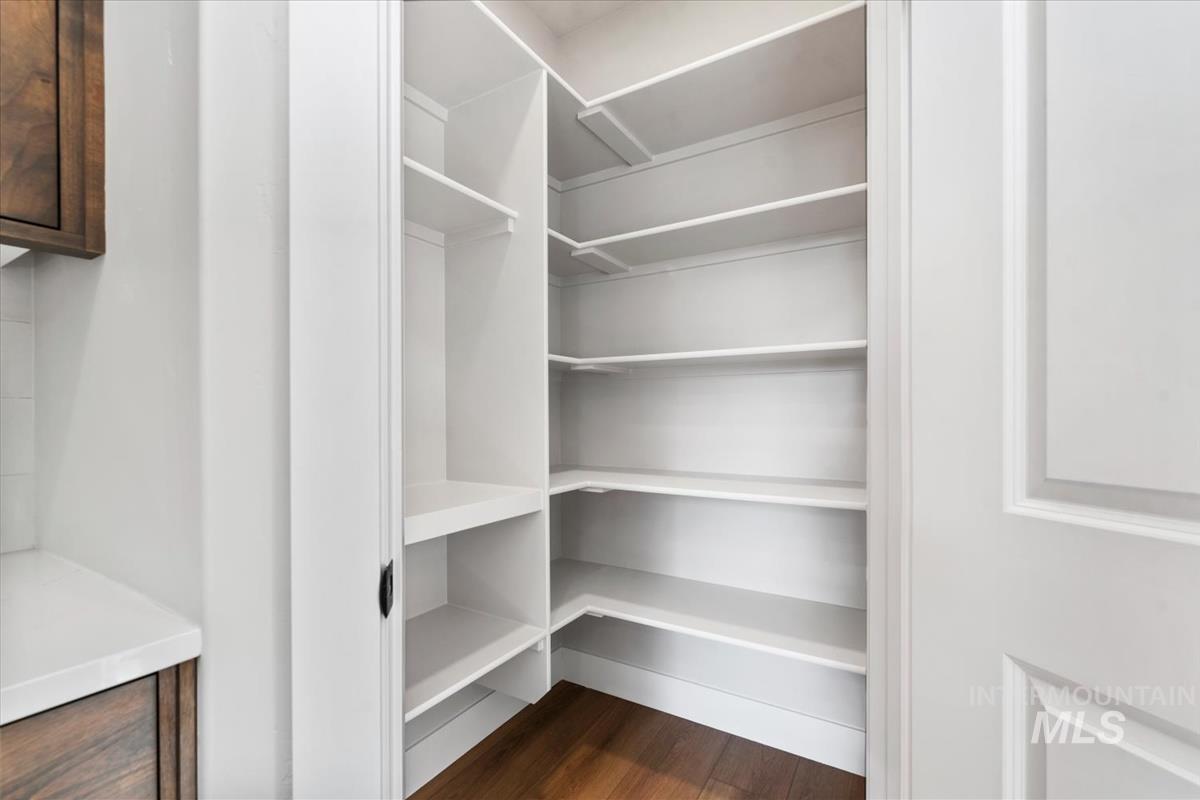 4223 Tropic Way Caldwell, ID 83607 - Photo 11 of 42 Expansive pantry with white shelving, wood-finish flooring, and white trim