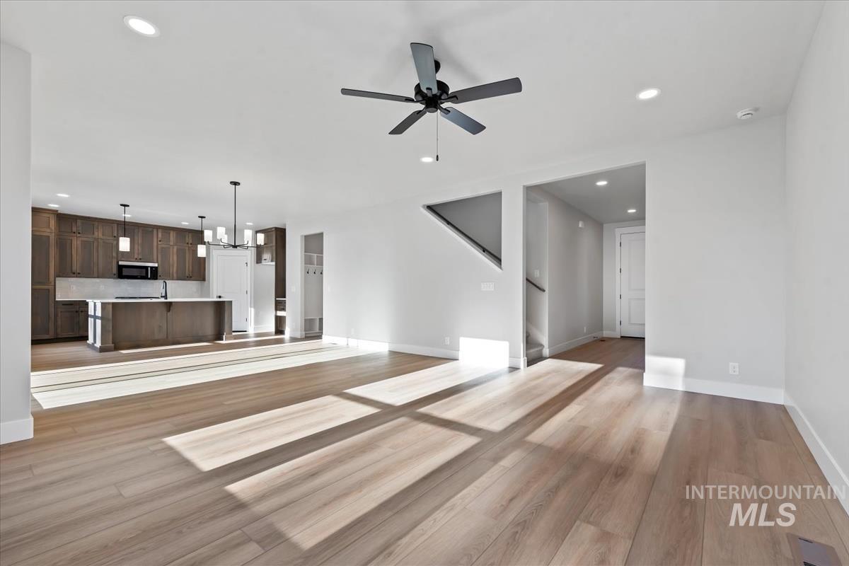 4223 Tropic Way Caldwell, ID 83607 - Photo 14 of 42 Open-concept living space featuring wood-finish flooring, recessed lighting, and a modern ceiling fan
