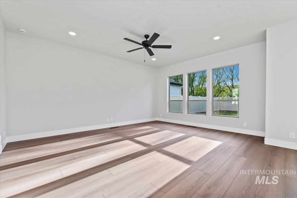 4223 Tropic Way Caldwell, ID 83607 - Photo 16 of 42 Spacious room featuring wood-finish flooring and a contemporary black ceiling fan