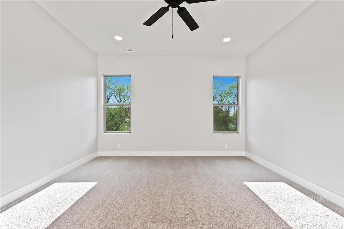 4223 Tropic Way Caldwell, ID 83607 - Photo 21 of 42 Spacious room featuring neutral carpeting, recessed lighting, a ceiling fan, and two windows