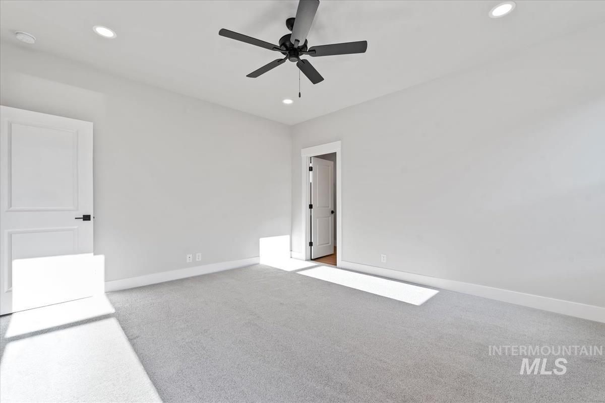 4223 Tropic Way Caldwell, ID 83607 - Photo 22 of 42 Spacious room featuring light-toned carpeting, recessed ceiling lighting, and a modern ceiling fan with dark blades