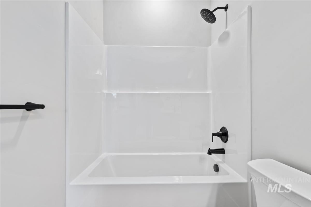 4223 Tropic Way Caldwell, ID 83607 - Photo 32 of 42 White bathtub and shower combination with matte black fixtures