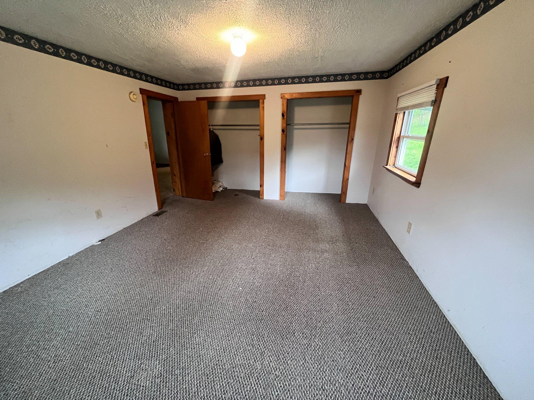 5151 Hutton Road Oakland, MD 21550 - Photo 14 of 32 a view of empty room with wooden floor and fan