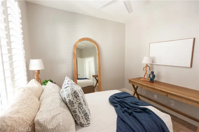 a bedroom with bed and a potted plant