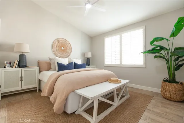 a bedroom with a bed and a potted plant