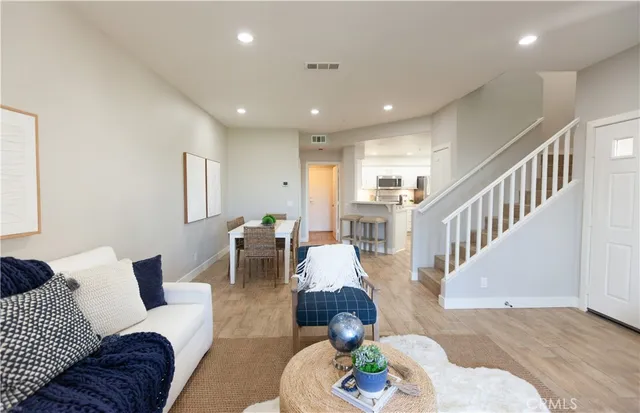 a living room with furniture and a chandelier