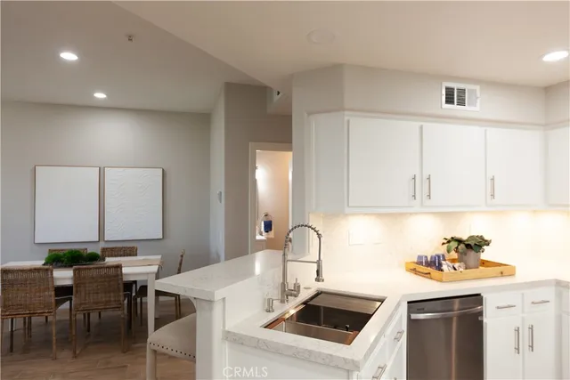 a kitchen that has a sink and a stove in it