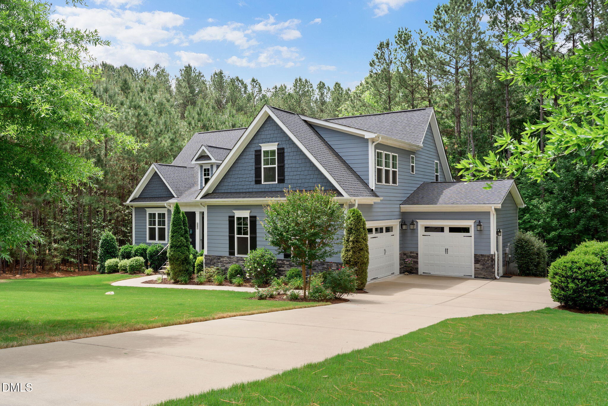 223 Colonial Ridge Drive Pittsboro, NC 27312 - Photo 2 of 47 a front view of a house with a yard and garage