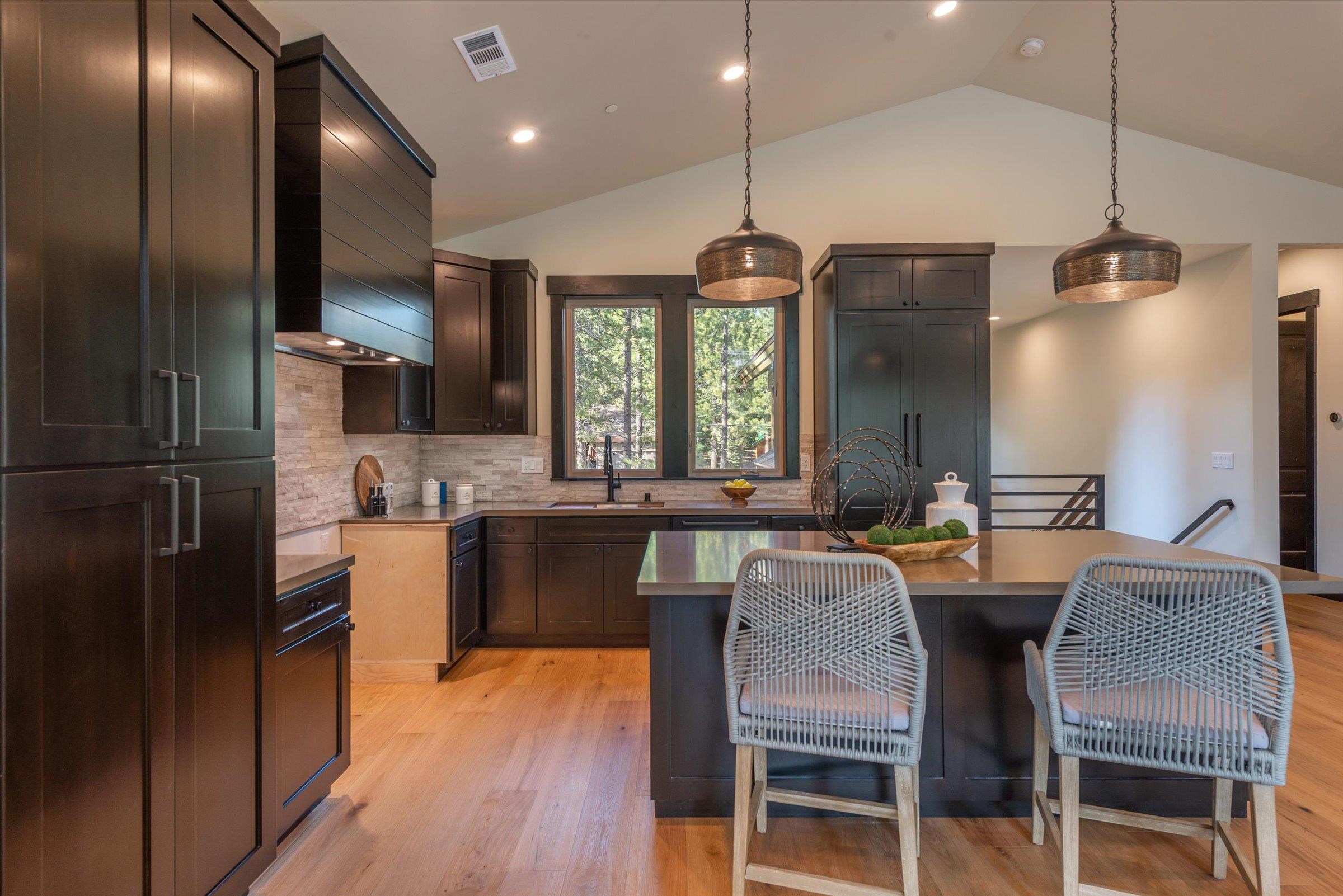 13510 Ski View Loop Truckee, CA 96161 - Photo 11 of 20 a kitchen with stainless steel appliances granite countertop a kitchen island hardwood floor sink stove dining table and chairs