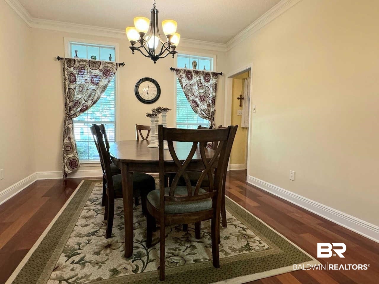 31163 Woodland Way Daphne, AL 36527 - Photo 21 of 44 Dining area featuring a notable chandelier, dark wood-type flooring, and crown molding