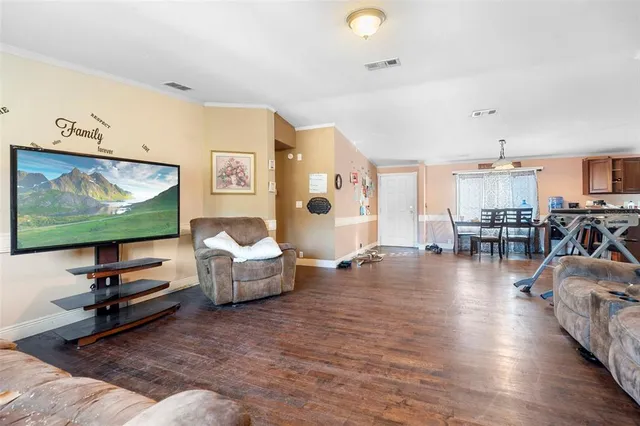 a view of a dining room with furniture and wooden floor