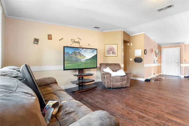 a dining room with furniture and a floor to ceiling window