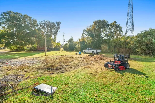 a view of yard with swimming pool and green space