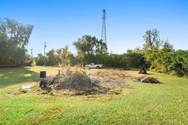 a view of a houses with yard and furniture