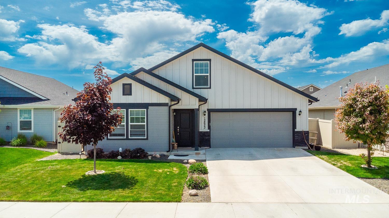 12623 Shadow Peak Street Caldwell, ID 83607 - Photo 1 of 50 Contemporary single-story residence featuring a two-tone exterior with vertical and horizontal siding