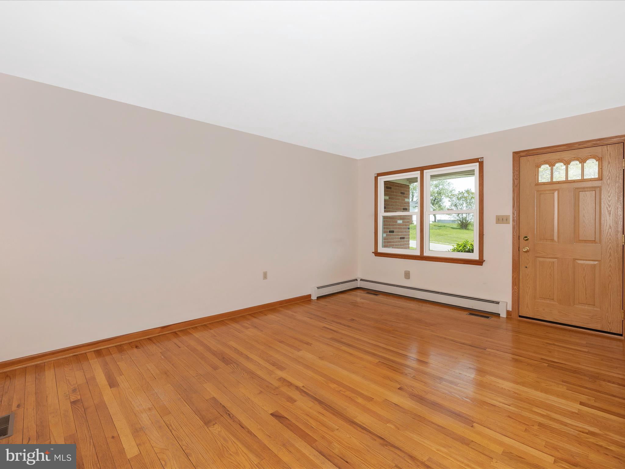 9203 Oak Tree Circle Frederick, MD 21701 - Photo 15 of 49 an empty room with wooden floor and windows
