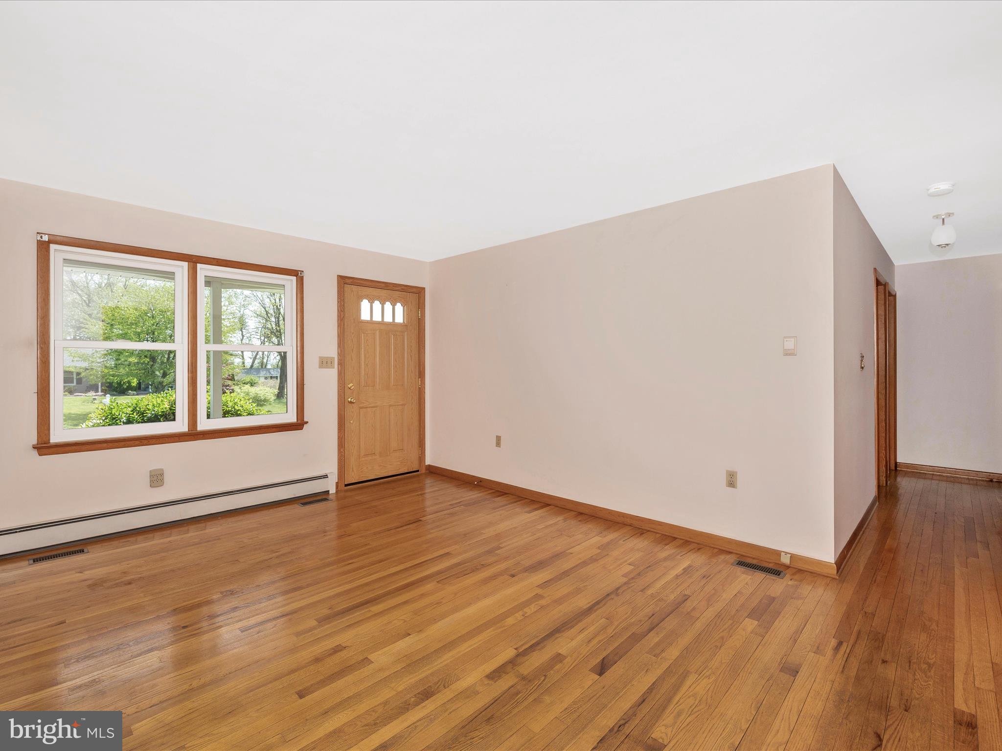 9203 Oak Tree Circle Frederick, MD 21701 - Photo 16 of 49 a view of an empty room with wooden floor and a window