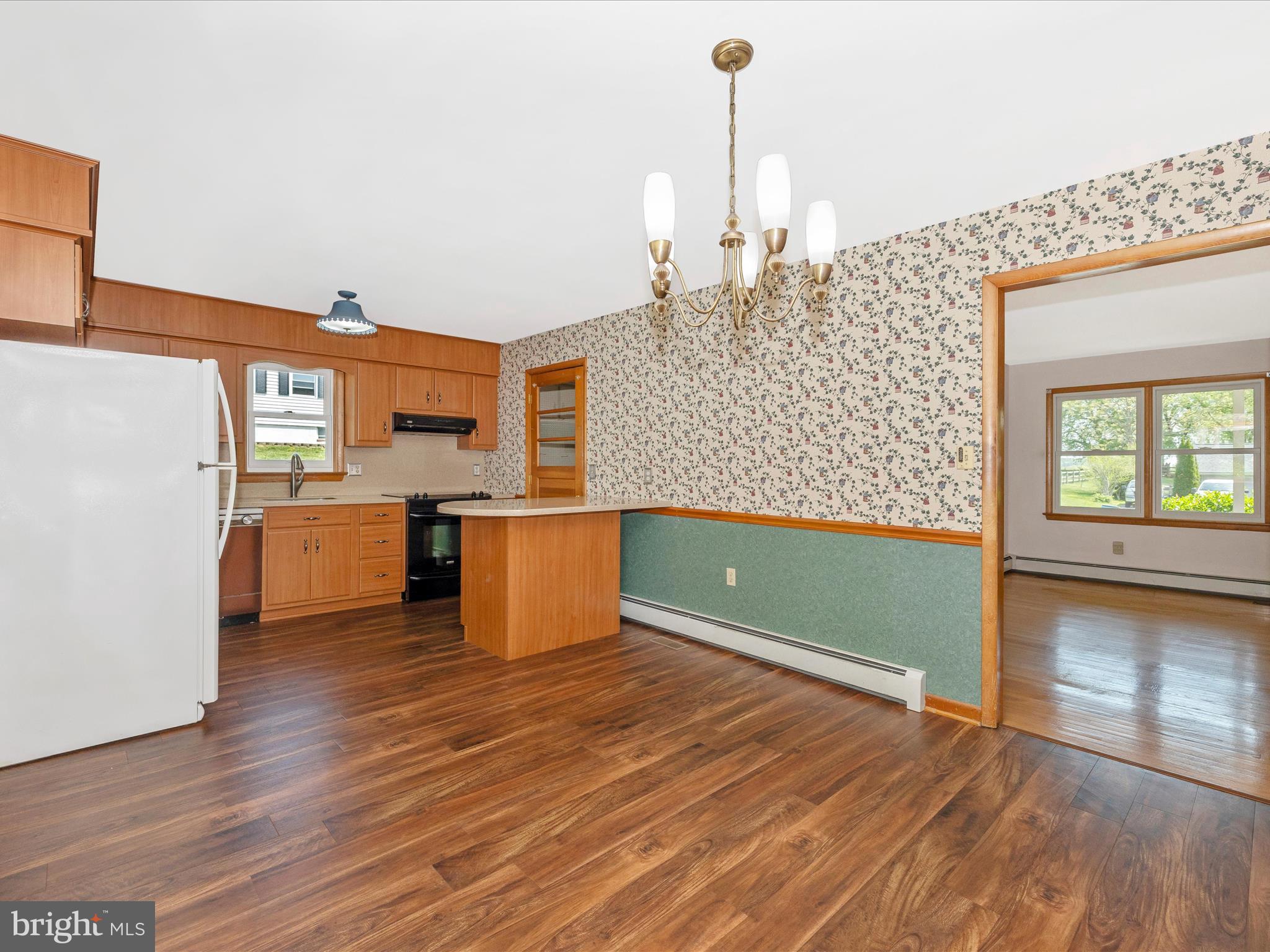 9203 Oak Tree Circle Frederick, MD 21701 - Photo 19 of 49 a kitchen with stainless steel appliances kitchen island wooden floors and a sink