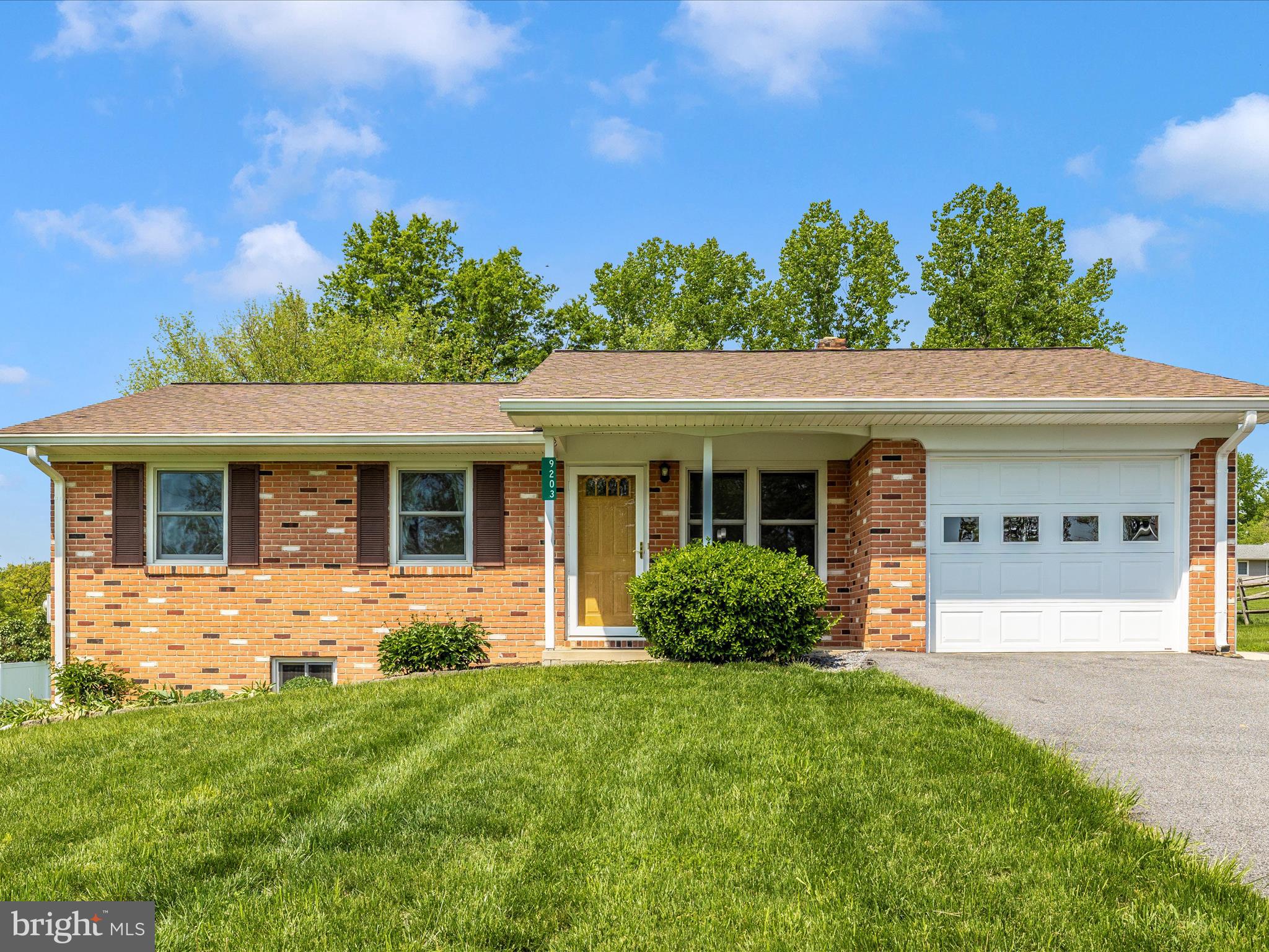 9203 Oak Tree Circle Frederick, MD 21701 - Photo 3 of 49 a front view of a house with garden