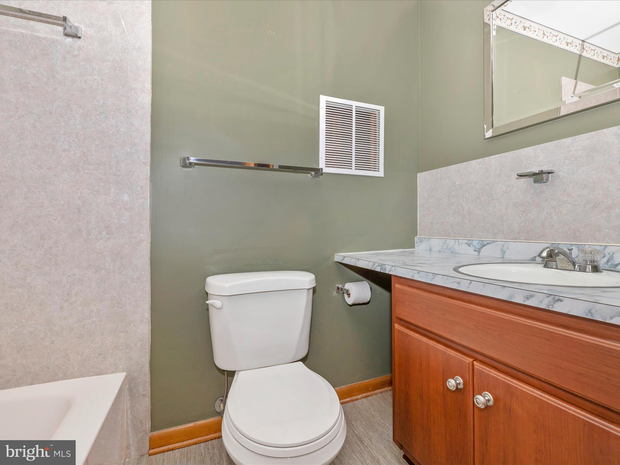 9203 Oak Tree Circle Frederick, MD 21701 - Photo 41 of 49 a bathroom with a granite countertop toilet sink and mirror