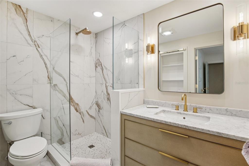 3390 Bayou Sound Longboat Key, FL 34228 - Photo 13 of 59 a bathroom with a granite countertop sink a toilet and shower