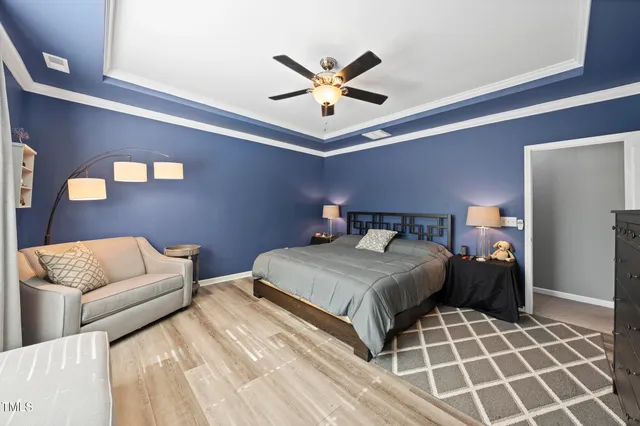 a bedroom with a bed and ceiling fan