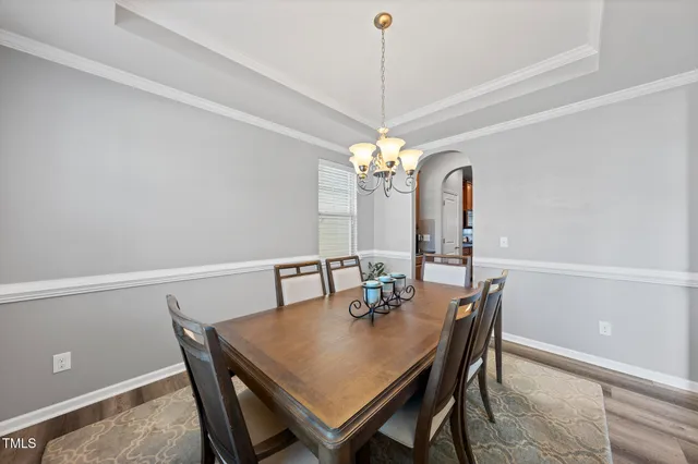 a view of a dining room with a table and chairs