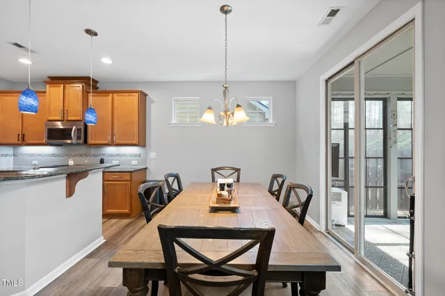 a kitchen with sink microwave dining table and chairs