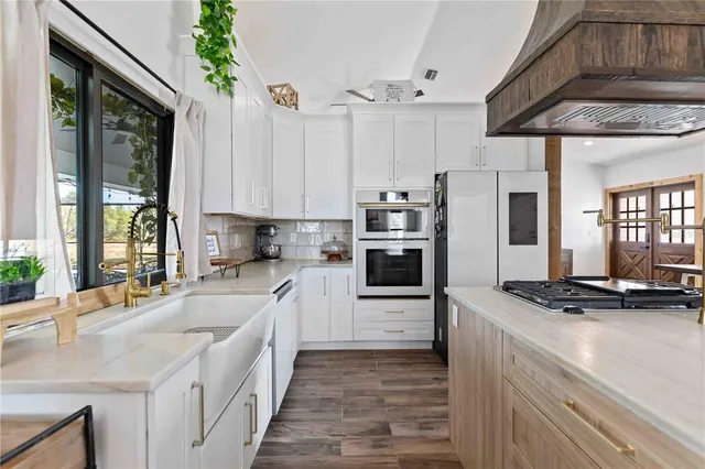 a view of a kitchen with furniture and wooden floor