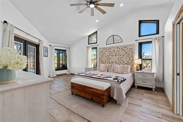 a bedroom with a large bed and a chandelier