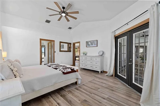 a large white bathroom with a sink a mirror and a bathtub