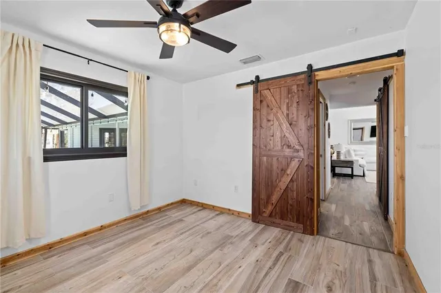 a view of empty room with wooden floor