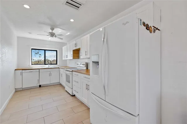 an empty room with windows and fireplace