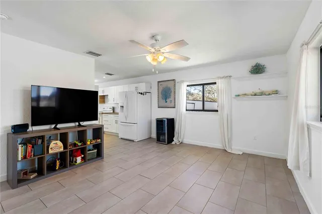 a bedroom with a bed and ceiling fan