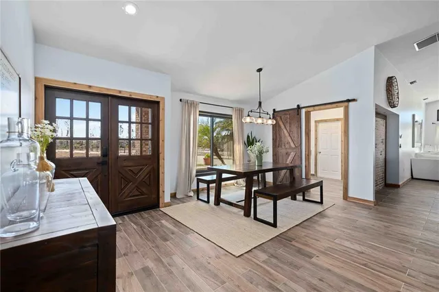 a view of a livingroom with furniture window and wooden floor