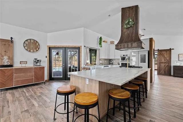 a large kitchen with a table and chairs