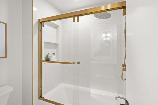 a bathroom with a glass shower door
