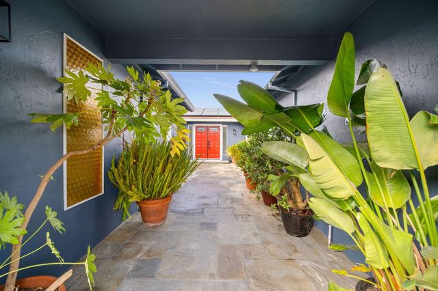 a view of yellow house with a yard