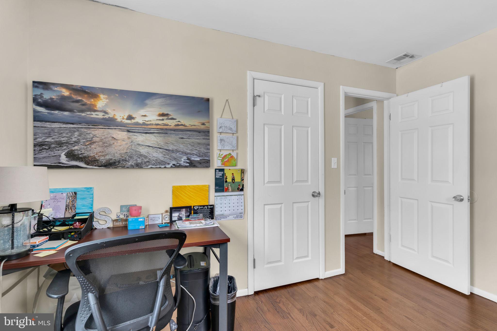 463 Ensign Road Forked River, NJ 08731 - Photo 16 of 21 a bed room with a table chair and wooden floor
