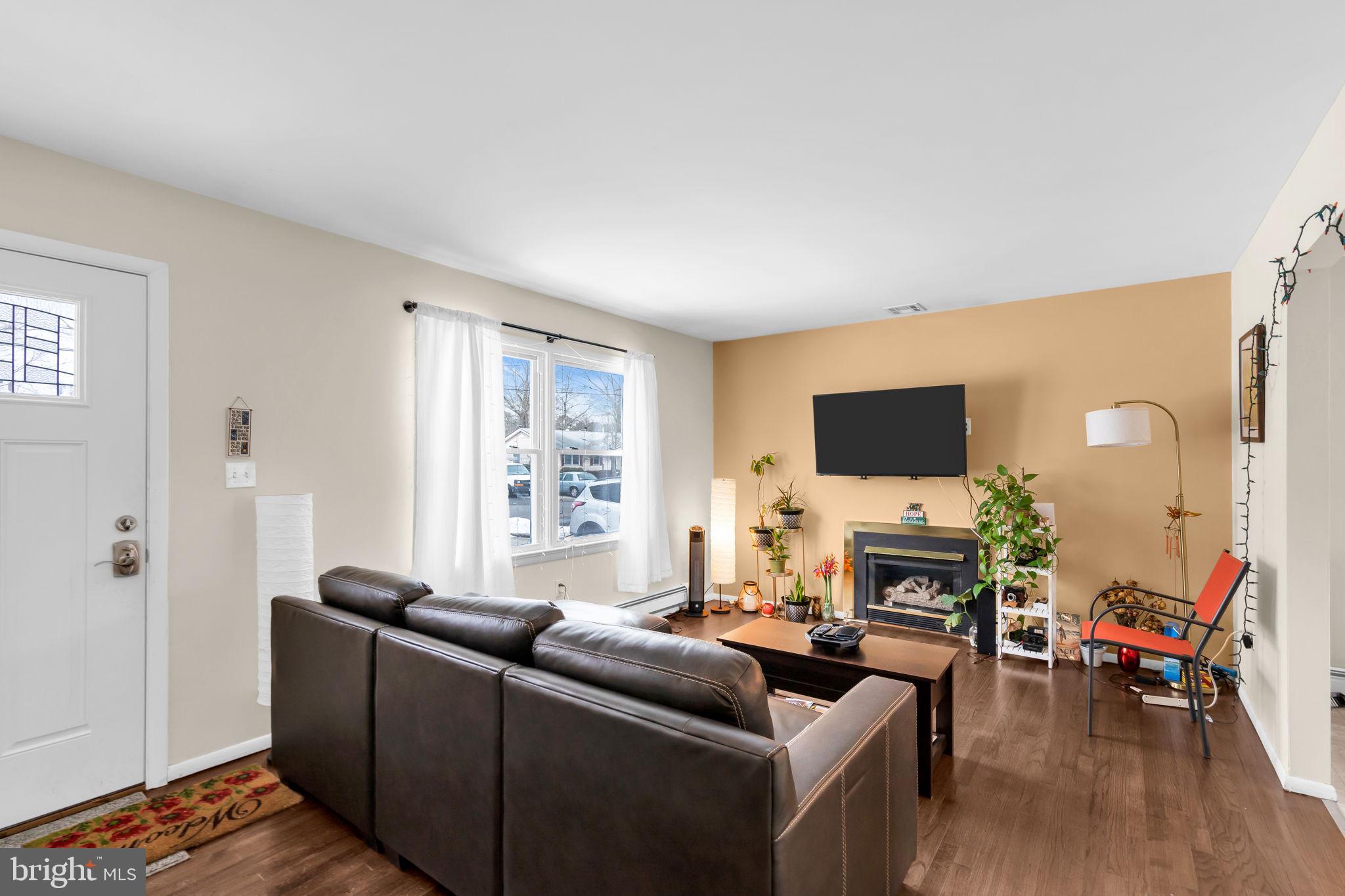 463 Ensign Road Forked River, NJ 08731 - Photo 7 of 21 a living room with furniture a fireplace and a flat screen tv