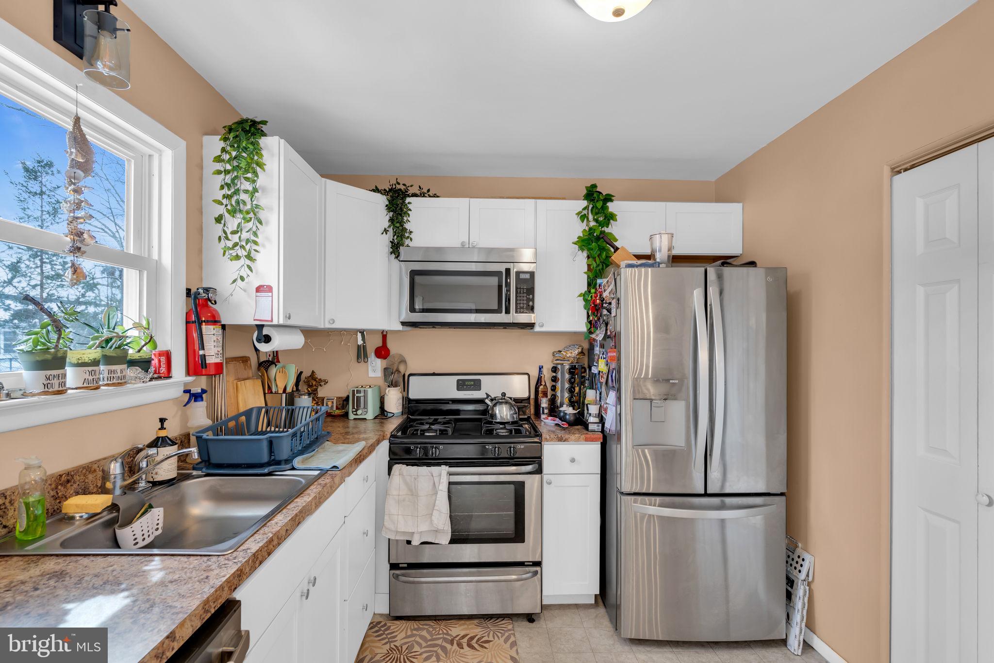 463 Ensign Road Forked River, NJ 08731 - Photo 8 of 21 a kitchen with a refrigerator and a sink