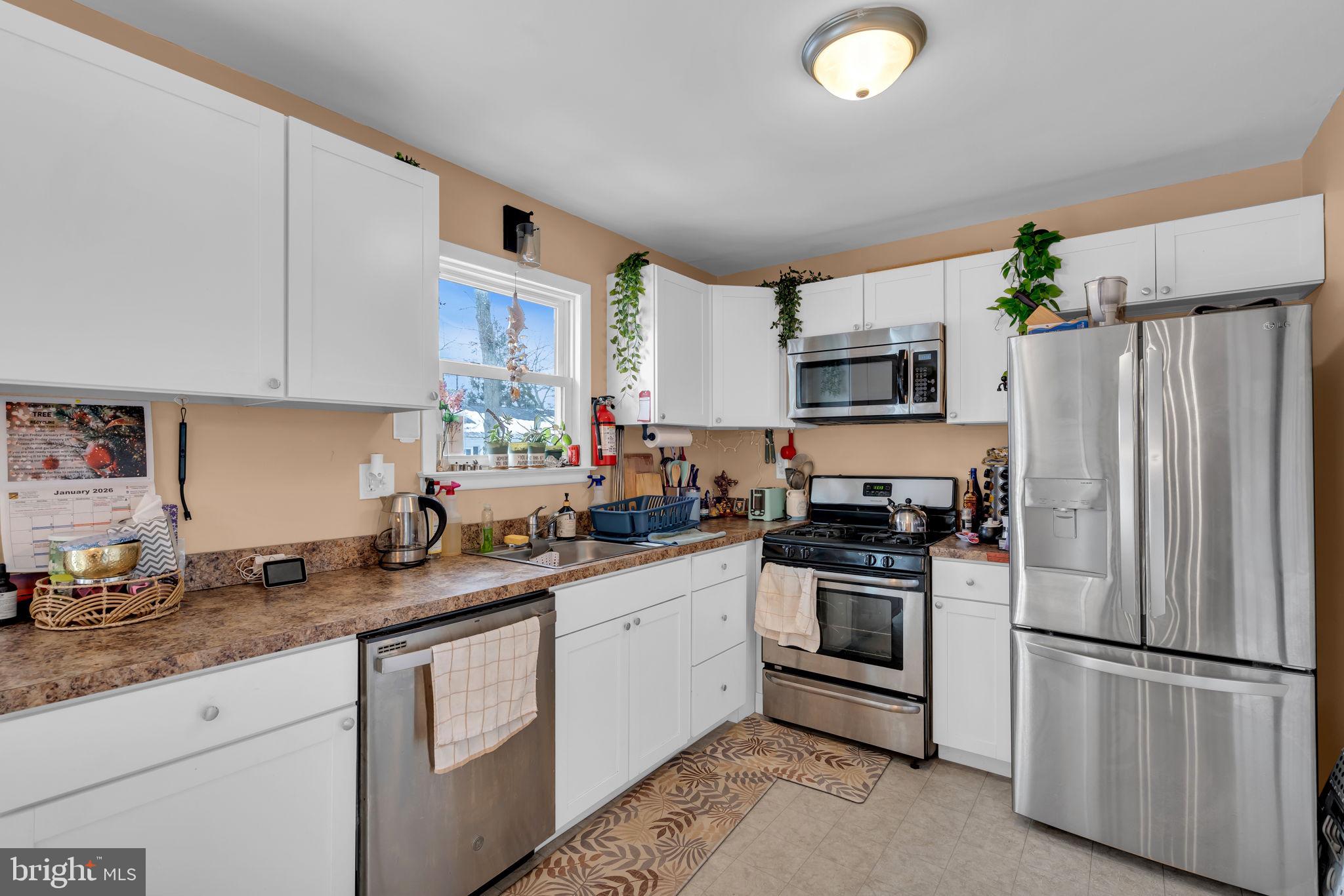 463 Ensign Road Forked River, NJ 08731 - Photo 10 of 21 a kitchen with stainless steel appliances granite countertop a refrigerator sink and stove
