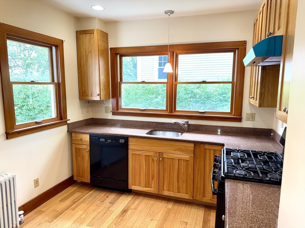 39 Newman Road Malden, MA 02148 - Photo 8 of 27 a kitchen with stainless steel appliances granite countertop a stove a sink and a window