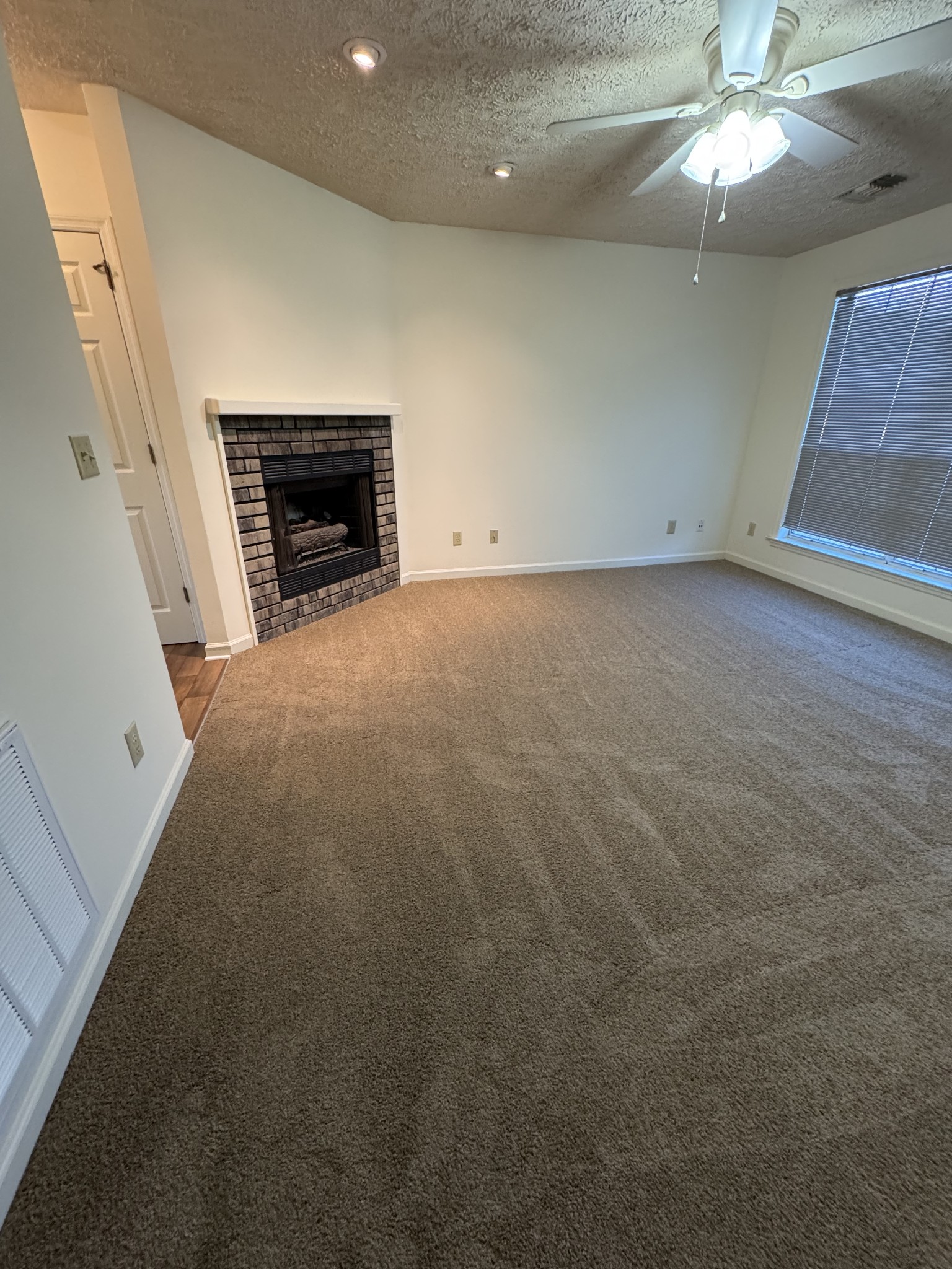 1714 Monument Lane, Unit B Lebanon, TN 37087 - Photo 3 of 9 an empty room with fireplace and a chandelier