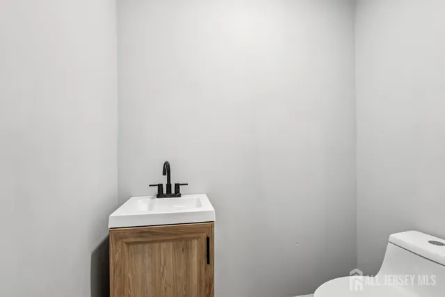 a bathroom with a sink a mirror and a toilet