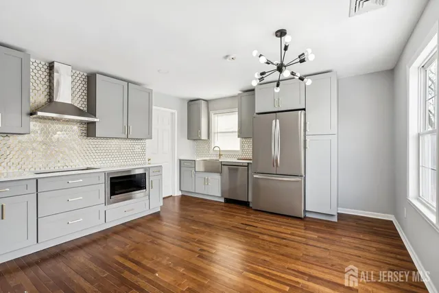 a kitchen with stainless steel appliances a refrigerator sink and cabinets