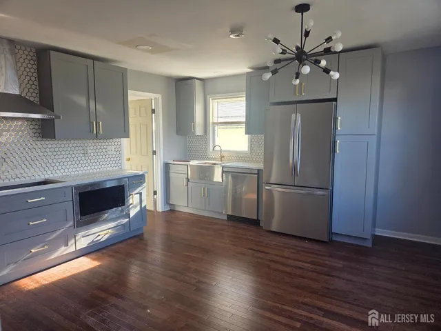 a kitchen with a refrigerator and a stove top oven