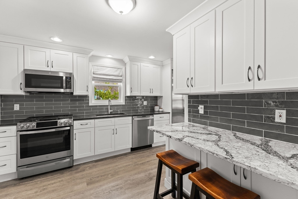 106 Circuit Avenue Wareham, MA 02571 - Photo 5 of 34 a kitchen with a stove a sink and a microwave